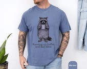 Photo 6 of 8: Blue jean raccoon shirt with a funny raccoon tee design holding coffee and the phrase Running on Coffee and Bad Ideas, cozy coffee humor shirt for introverts, caffeine lovers, and a gift for him or her