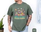 Photo 5 of 14: Moss green unisex t shirt featuring a cute raccoon graphic tee with the playful phrase “Embrace Your Inner Trash Panda,” perfect funny animal tee for a cozy, sarcastic gift for him or any raccoon lover