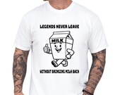 Photo 1 of 8: Funny dad shirt on a white tee featuring a smiling milk carton character and the phrase Legends Never Leave Without Bringing Milk Back, a playful fathers day gift for a cool papa outfit and family gag clothes with snack quest design charm