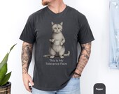 Photo 2 of 8: Relaxed-fit soft cotton blue jean unisex t shirt on a male model showing a grumpy cat holding a coffee mug and the caption "This Is My Tolerance Face", a funny cat shirt and cat meme tee with dry, sarcastic humor, perfect novelty cat tee and gift for him or cat owner