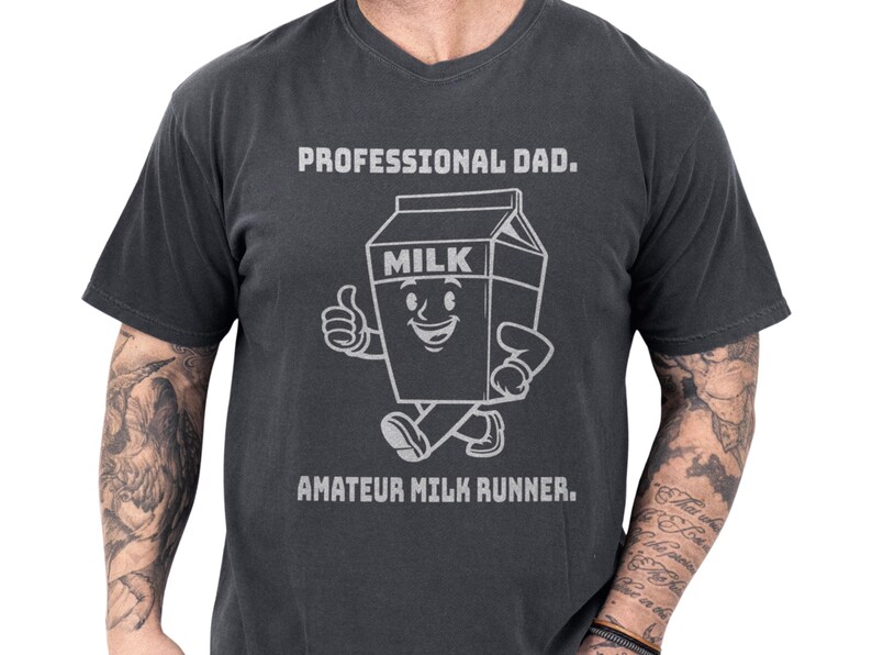 Funny dad shirt in a vintage black tee style, featuring a smiling milk carton art character with the text Professional Dad and Amateur Milk Runner, a playful fathers day gift with cool papa outfit energy and a clever cereal run joke for everyday dad humor society