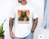 Photo 4 of 8: Cozy garment-dyed dad joke tee displayed on a unisex dad t-shirt model in a relaxed casual fit, shown in five soft, muted colors — Black, White, Pepper, Moss, Blue Jean — perfect funny dad shirt for Father's Day, birthday, or everyday dad life gift