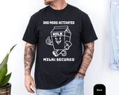 Photo 3 of 8: Funny dad shirt with a playful milk carton art graphic and Dad Mode Activated slogan, styled for a cool papa outfit or fathers day gift, featuring a bold black tee with a cheerful snack quest design that makes a fun gag gift for dad