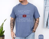 Photo 6 of 8: Male hiker wearing a soft cotton funny dad tee with a retro red play icon and a cheeky YouTube repair joke about fixing things, relaxed fit and comfort dye colors, styled as handyman father top and men's humor apparel ideal as a Father's Day present or birthday gag gift