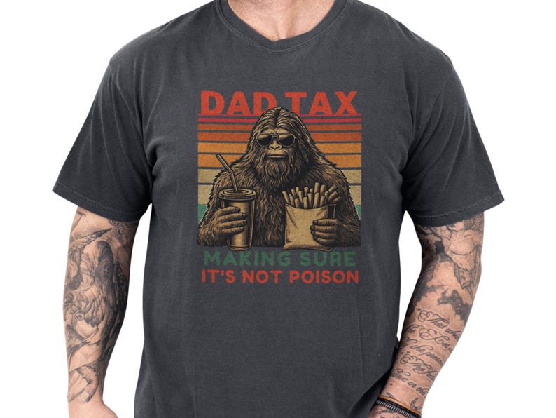 Charcoal Comfort Colors dad tax shirt with a retro sunset graphic of a sasquatch holding fries and a drink, cheeky "making sure it's not poison" tagline — nostalgic bigfoot dad tee and funny dad tee, cozy vintage look ideal Father's Day gift or gifts for dad for backyard BBQs and everyday wear