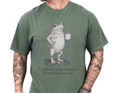 Photo 1 of 8: Relaxed moss green unisex t shirt featuring a vintage sketch frog holding a coffee mug and the witty slogan 'The Weird Was Going to Come Out Anyway', a funny frog shirt and frog graphic tee with quirky humor and introvert humor vibes, cozy gift for him