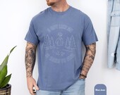 Photo 6 of 8: Casual blue garment-dyed Comfort Colors tee on a tattooed model, soft vintage-faded print of a cheeky outdoors slogan with trees and icons, relaxed unisex fit for casual everyday wear, novelty graphic tee and sarcastic tshirt that makes a great gift for him