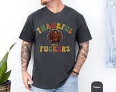 Photo 2 of 8: Unisex moss green vintage-fade tee featuring a cheeky turkey illustration and bold retro lettering with an edgy thankful joke, a friendsgiving and thanksgiving funny parody shirt that reads as an inappropriate, rude shirt and perfect funny grateful gift for friends