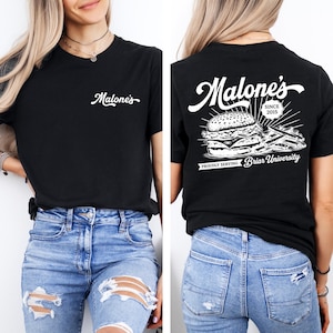 May include: Black t-shirt with the white text "Malone's" on the front and a burger and fries graphic on the back. The back of the shirt also includes the text "SINCE 2015" and "PROUDLY SERVING Briar University".