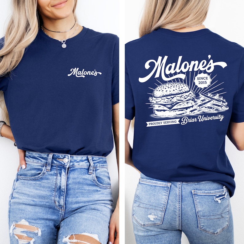 May include: Navy blue t-shirt with the word "Malone's" in white script on the front. The back of the shirt features a burger and fries graphic with the text "Malone's Since 2015" and "Proudly Serving Briar University."