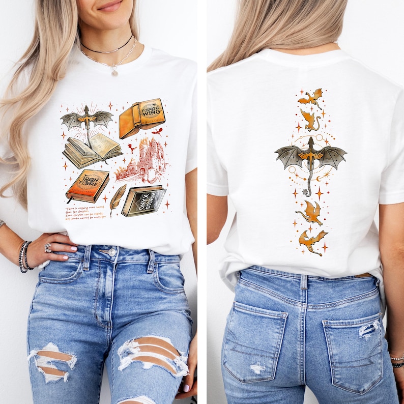 May include: White t-shirt featuring a fantasy-themed graphic on the front and back. The front design includes books, a dragon, and a castle. The back features a dragon and smaller flying dragons. The shirt is paired with blue jeans.