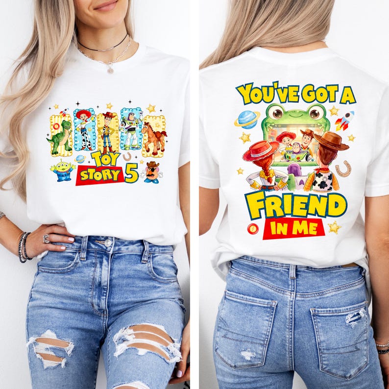 May include: A white t-shirt featuring Toy Story graphics. The front displays characters like Woody, Buzz Lightyear, and Rex with the text "TOY STORY 5". The back shows a frog-themed screen with characters and the text "YOU'VE GOT A FRIEND IN ME".