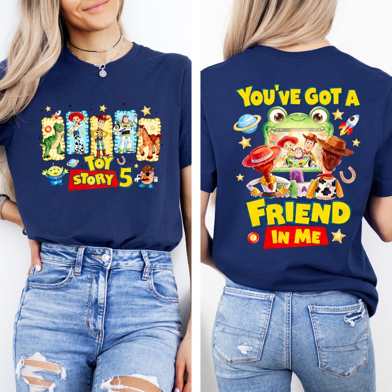 May include: A navy blue t-shirt featuring Toy Story 5 graphics. The front displays characters in rectangular frames with the text Toy Story 5. The back shows characters watching a screen with a frog, with the text You've Got A Friend In Me.