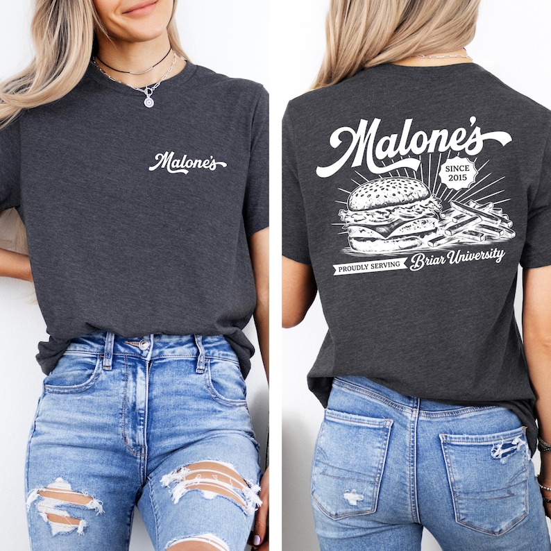 May include: Dark gray t-shirt with the word "Malone's" in white script on the front. The back of the shirt features a burger and fries graphic with the text "Malone's Since 2015" and "Proudly Serving Briar University."
