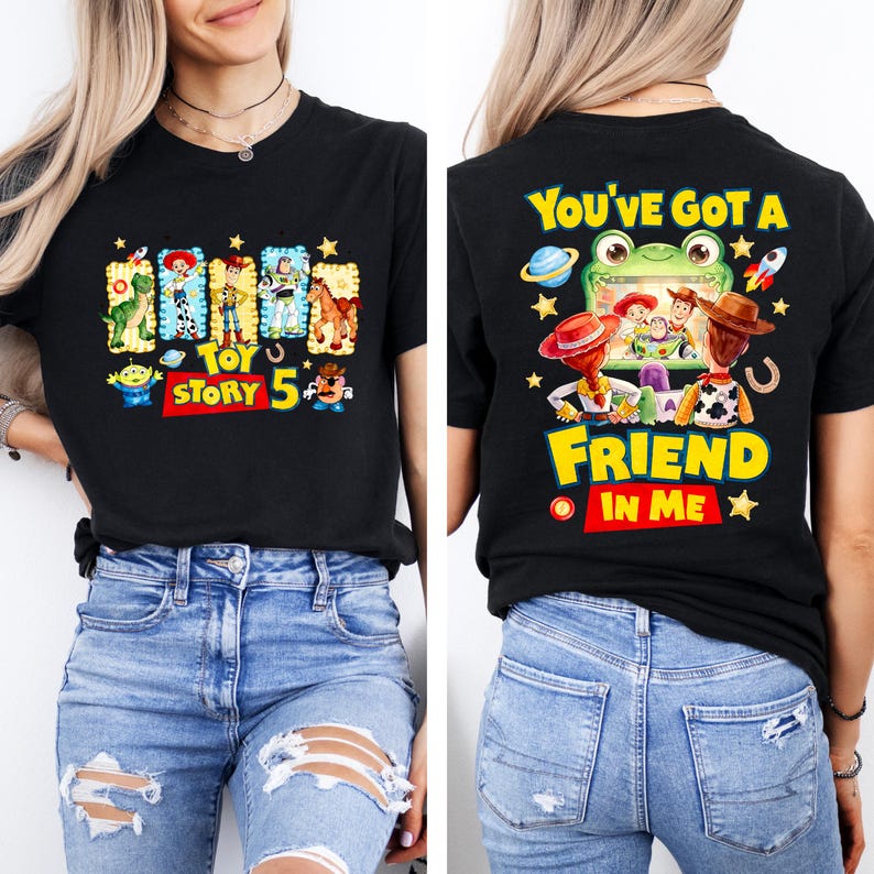 May include: A black short-sleeve t-shirt featuring Toy Story 5 graphics. The front displays characters in rectangular frames with the text Toy Story 5. The back shows characters watching a screen with the text You've Got A Friend In Me.