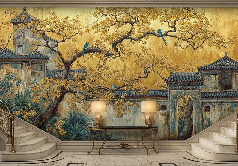 May include: A detailed mural depicts an Asian-inspired landscape with gold-toned trees, blue birds, and traditional buildings. The scene includes a staircase, a console table with lamps, and a marble floor, creating a serene and elegant atmosphere.
