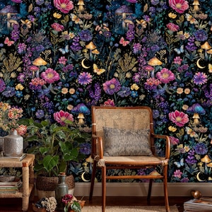 May include: A colourful wallpaper design with a dark backdrop, showcasing flowers, mushrooms, butterflies, and crescent moons. The image includes a wooden chair with a woven back and a cushion, plus potted plants and vases.