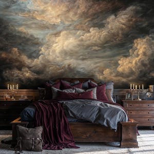 May include: A bedroom with a large wooden bed, grey bedding, and burgundy pillows and throw. The wall is a mural of a dramatic cloudy sky. Two dark wooden bedside tables with candle holders are on either side of the bed.
