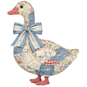 May include: A decorative fabric goose figure crafted from a patchwork of floral, denim, and red-and-white gingham textiles. The goose features a large blue-and-white gingham bow with lace trim at the neck, a black bead eye, and red gingham feet.