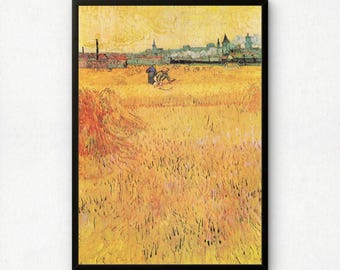 May include: A framed art print featuring a golden wheat field under a yellow sky. Two figures work in the center of the field, with a distant town silhouette on the horizon. The painting uses thick, textured brushstrokes in shades of yellow, orange, and green to depict a rural landscape scene.