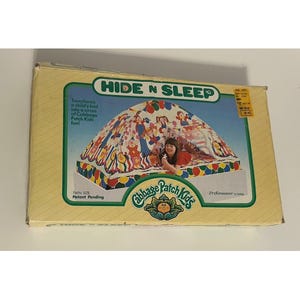 May include: A yellow box for a "Hide N Sleep" tent, designed to transform a child's bed into a circus of Cabbage Patch Kids fun. The tent features colorful illustrations and the words "Twin Size" and "Patent Pending".