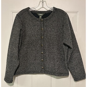 May include: A dark gray button-up cardigan with a textured knit pattern. The cardigan has a round neckline and is fastened with six gold-colored buttons. The L.L.Bean brand label is visible near the neckline.