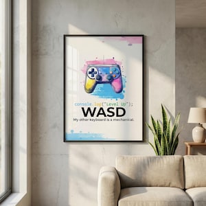 Watercolor gamer wall art featuring a colorful game controller with paint splatters. Text includes JavaScript code 'console.log("Level Up");', the 'WASD' movement keys, and the quote "My other keyboard is a mechanical." Perfect for gaming room decor and software engineers.