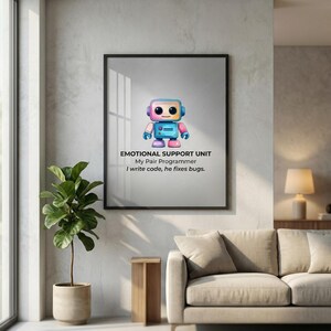 Cute watercolor robot illustration titled "Emotional Support Unit." Below the robot, text reads "My Pair Programmer: I write code, he fixes bugs." A whimsical and funny office decor piece for computer science students, coders, and IT professionals.