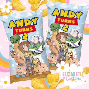 May include: Two bags of potato chips with a blue sky background and the text "ANDY TURNS 2". The bags feature cartoon characters including a dinosaur, Woody, Buzz Lightyear, and other Toy Story characters. The chips are scattered around the bags.