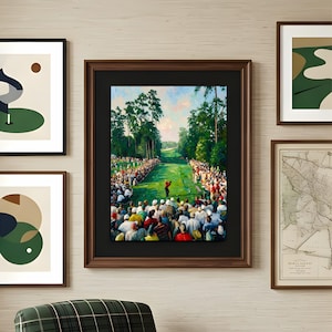 May include: A framed print of a golf course scene, showing a golfer in red teeing off, with spectators lining the fairway. The print is in a dark brown frame, displayed alongside other framed artworks.