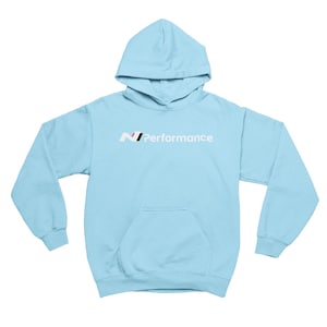 May include: A pale blue hoodie with a hood and a front pocket. The text "N Performance" is printed on the front in white, black, and red.