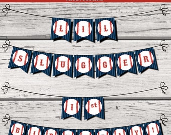 May include: A baseball-themed banner with blue and white striped flags. Each flag features a red baseball with white stitching and a letter. The banner reads "Little Slugger 1st Birthday!"