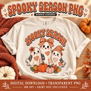 May include: A cream-colored t-shirt featuring a graphic of three ghosts with patchwork patterns, orange bows, and hats. The text above the ghosts reads SPOOKY SEASON in orange letters. The design includes orange pumpkins and autumn leaves.
