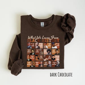 May include: Dark chocolate-colored sweatshirt featuring the text "What We Learn From Black History" above a grid of historical figures. The sweatshirt has a crew neck and long sleeves. The words "Dark Chocolate" are printed at the bottom.
