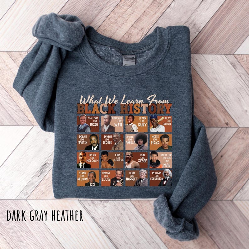 May include: Dark gray heather sweatshirt with the text "What We Learn From Black History" and portraits of historical figures. The sweatshirt features a crew neck and long sleeves. The text "DARK GRAY HEATHER" is at the bottom.