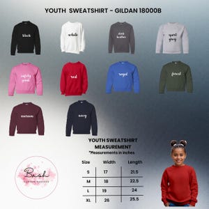 May include: A selection of youth sweatshirts in various colors, including black, white, and red. The image displays the sweatshirts with the color names written on them. Measurements are provided in inches for sizes S, M, L, and XL. The brand is Gildan 18000B.