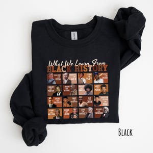 May include: Black sweatshirt with the text "What We Learn From Black History" and portraits of historical figures. The sweatshirt features a grid of images with phrases like "Challenge Like Rosa" and "Dream Like Martin."