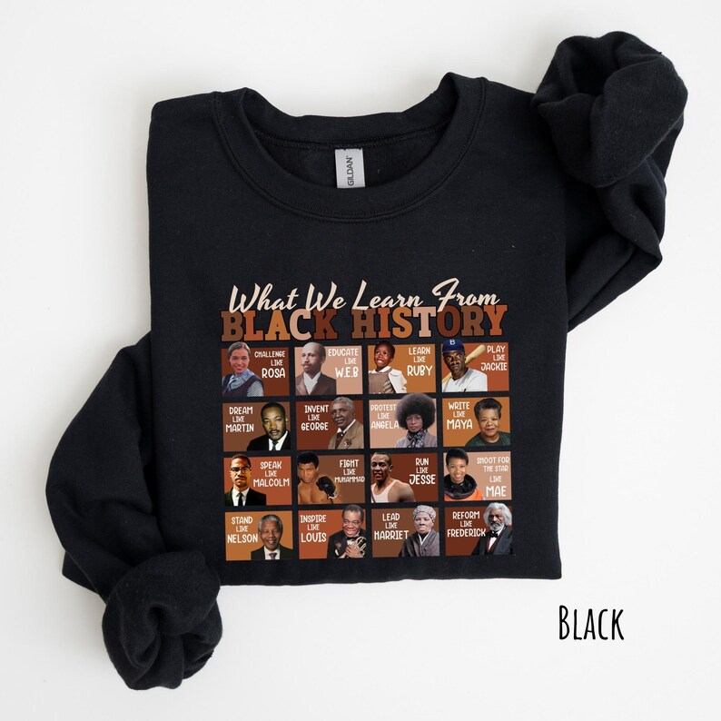 May include: Black sweatshirt with the text "What We Learn From Black History" and portraits of historical figures. The sweatshirt features a grid of images with phrases like "Challenge Like Rosa" and "Dream Like Martin."