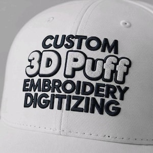 May include: A white baseball cap with the words "CUSTOM 3D Puff EMBROIDERY DIGITIZING" embroidered in black and white. The text is in a bold, puffy font, creating a 3D effect. The cap is made of a textured fabric.