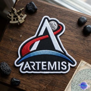 May include: A white ceramic mug with a black handle and the text "But First, Coffee" in a black, bold font. The mug is on a white surface.