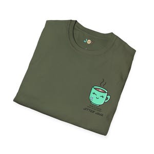 May include: Olive green t-shirt with a cartoon coffee cup graphic. The cup is light green with a smiling face and steam rising from the top. Text below the cup reads "Run it again! Just to be sure!" and "Jitter Java."