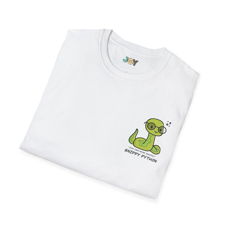May include: White t-shirt with a cartoon green snake wearing glasses. The shirt has the text "Just one more snippet" and "Snippy Python". The word "JOY" is printed on the upper left side of the shirt.