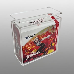 May include: A clear acrylic display case with a removable lid, showcasing a Marvel Spider-Man Collector Boosters box. The box features a vibrant illustration of Spider-Gwen in action, with the Marvel and Spider-Man logos prominently displayed.
