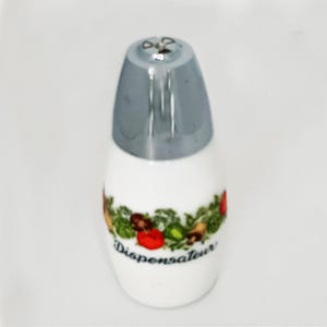 May include: White ceramic dispenser with a silver lid. The dispenser features a colorful band of vegetables and the word "Dispenseur" in a script font.