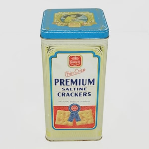 Tin Nabisco™ Premium Saltine Crackers 1993 Vintage Ad Image Cracker Keeper Kitchen Ivory Blue Blue Lid Chef Boy Yellow Raincoat Lady Shopper