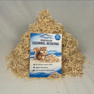 May include: A large pile of light tan, shredded aspen wood fibers for animal bedding. A rectangular product label is centered in front, featuring a cartoon squirrel, blue mountain graphics, and the text Premium Squirrel Bedding.