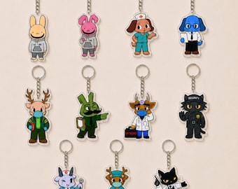 May include: A collection of eleven acrylic keychains featuring various cartoon characters in professional attire, including a nurse, doctor, security guard, and office workers. Each character is attached to a silver metal chain and ring.