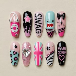 May include: A set of ten press-on nails featuring diverse designs including a pink music player, black flames with a pink star, the word SWAG, a teal creature with a chain, a black bow, leopard print, a heart gem, a Union Jack, zebra print, and SCENE QUEEN.
