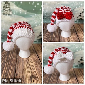 May include: A white and red crocheted Santa hat with a white pom-pom and a white bow. The hat is on a white mannequin head.