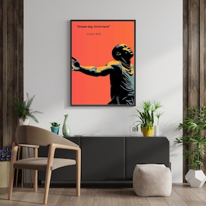 May include: A framed wall art print featuring a stylised graphic illustration of Usain Bolt in black and yellow against a vibrant orange background, with the text "Dream big. Grind hard" and "-Usain Bolt" printed in black at the top.